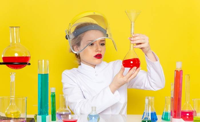 8 Tips to Increase Speed in the ACT Science Section front view young female chemist white suit with ed solutions working with them wearing helmet yellow space chemistry tests 140725 28952